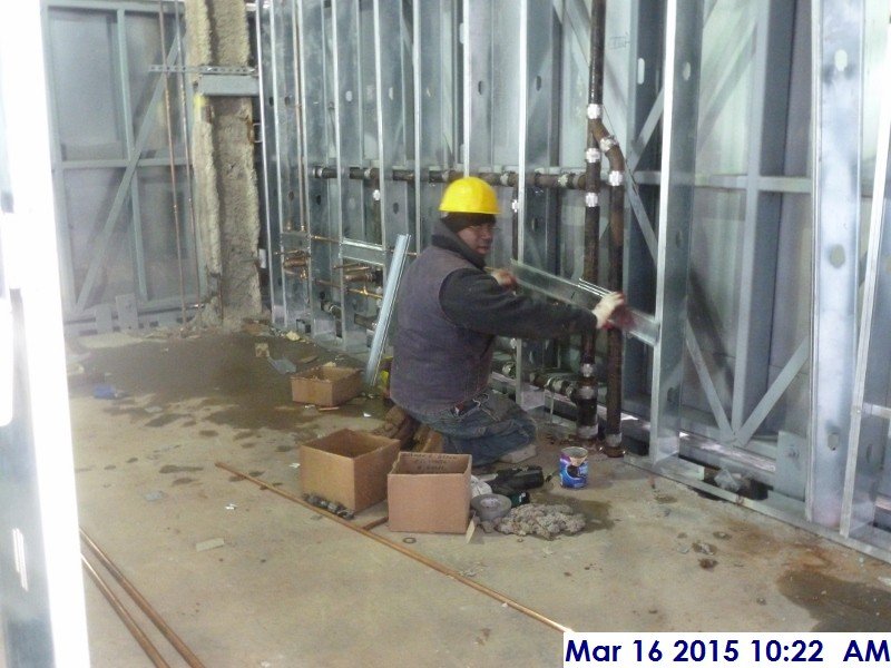 Installing copper piping at the 4th floor bathrooms Facing North
